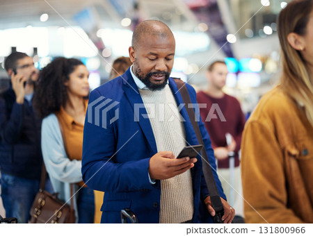 Travel, search and phone with black man in airport for flight, vacation and immigration. Queue, communication and technology with businessman in line with luggage for trip, holiday and first class Travel, search and phone with black man in airport for flight, vacation and immigration. Queue, communication and technology with businessman in line with luggage for trip, holiday and first class 131800966