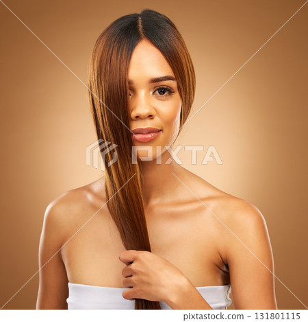 Haircare, studio and portrait of woman holding strong hair in hand with texture and salon shine. Skincare model, mockup and beauty, healthy straight hairstyle with keratin product on brown background Haircare, studio and portrait of woman holding strong hair in hand with texture and salon shine. Skincare model, mockup and beauty, healthy straight hairstyle with keratin product on brown background 131801115