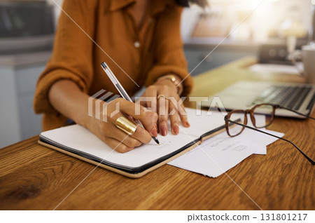 Closeup, writing and woman on laptop with documents for budget, savings and paying bills in her home. Paper, financial and future planning, investment and growth by female checking finance notes Closeup, writing and woman on laptop with documents for budget, savings and paying bills in her home. Paper, financial and future planning, investment and growth by female checking finance notes 131801217