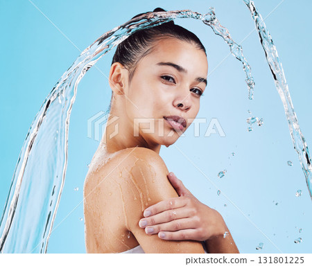 Water drops, skincare and portrait of woman with health, wellness and hygiene isolated on blue studio background. Shower, dermatology and cosmetic beauty glow, model in skin care treatment or routine 131801225