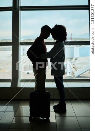 Silhouette, travel and love with couple in airport and hug for departure, flight and say goodbye. Shadow, holiday and sad man and woman leave in embrace by window for journey, international 131801277