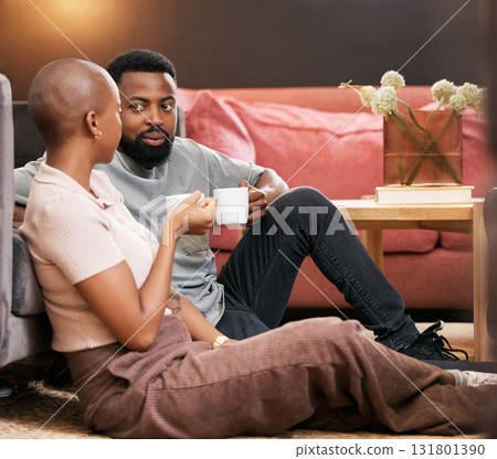 Coffee, love and valentines day with a black couple sitting on the living room floor together for romance. Relax, date or romantic with a man and woman spending time in their home for bonding Coffee, love and valentines day with a black couple sitting on the living room floor together for romance. Relax, date or romantic with a man and woman spending time in their home for bonding 131801390