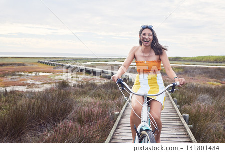 Portrait, bike and mockup with a woman cycling outdoor in nature for freedom, fun or adventure in the countryside. Happy, smile and bicycle with a female cyclist outside in the wilderness for travel Portrait, bike and mockup with a woman cycling outdoor in nature for freedom, fun or adventure in the countryside. Happy, smile and bicycle with a female cyclist outside in the wilderness for travel 131801484