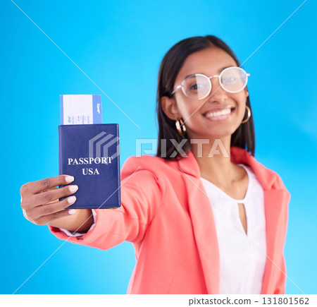 Passport, ticket and portrait of woman in travel, flight or USA documents against a blue studio background. Happy female business traveler smile holding international boarding pass or booking trip 131801562