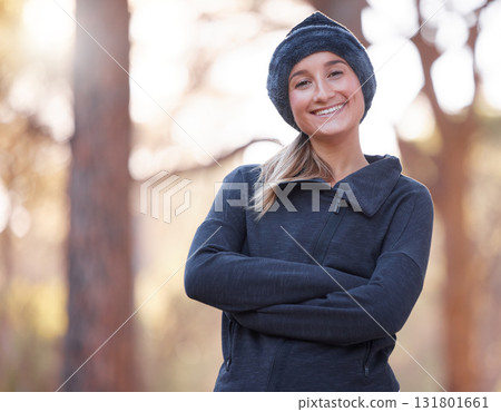 Portrait, arms crossed and smile of woman hiking outdoors for health and fitness. Winter sports, training and happy, confident and proud female hiker from Canada ready to start exercise in forest. 131801661