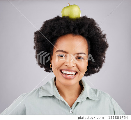Apple on head, balance and portrait of black woman in studio for nutrition, wellness and healthy snack. Food, diet and girl smile with fruit for detox, vitamins and weight loss on white background 131801764