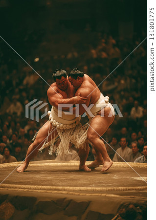 Sumo wrestler performs a shoulder throw during a competitive match in Japan 131801775