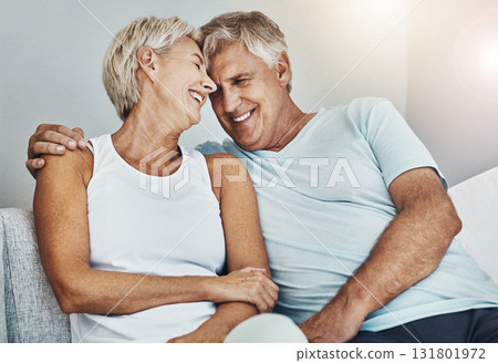 Love, laughing and retirement with a senior couple sitting in the living room of their home together. Happy, smile or relax with a mature man and woman joking while bonding on the couch in a house Love, laughing and retirement with a senior couple sitting in the living room of their home together. Happy, smile or relax with a mature man and woman joking while bonding on the couch in a house 131801972