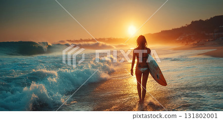 Muscular woman surfer with surfboard walks along beach towards ocean at sunset 131802001