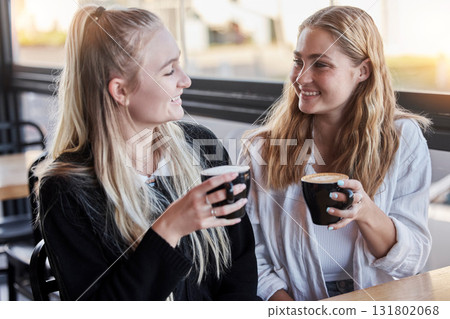 Coffee shop, couple of friends and happy social date or conversation in morning for gen z lifestyle. Young people or youth women talking together with latte cup in cafe or restaurant on student break 131802068