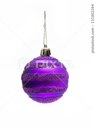 Purple Christmas ball ornament with textured glitter stripes on a white background  131802264