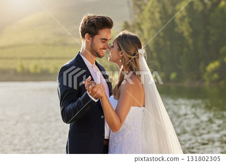 Wedding, dance and couple love by lake with care and support from marriage together by water. Nature, happiness and holding hands of young people with a happy smile from trust and commitment event 131802305
