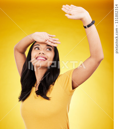 Freedom, happy and dance with a woman on a yellow background in studio feeling positive or carefree. Energy, fashion and smile with an attractive young gen z female dancing or moving to music Freedom, happy and dance with a woman on a yellow background in studio feeling positive or carefree. Energy, fashion and smile with an attractive young gen z female dancing or moving to music 131802314
