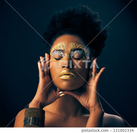 Beauty, gold and metallic with black woman and makeup in studio for luxury, cosmetics and African pride. Natural, creative and goddess with female model on background for queen, bronze or glamour art Beauty, gold and metallic with black woman and makeup in studio for luxury, cosmetics and African pride. Natural, creative and goddess with female model on background for queen, bronze or glamour art 131802334