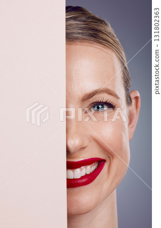 Half, mockup and portrait of a woman with makeup isolated on a grey studio background. Space, cosmetics and face of a young, smiling and confident happy model with cosmetic glamour on a backdrop 131802363