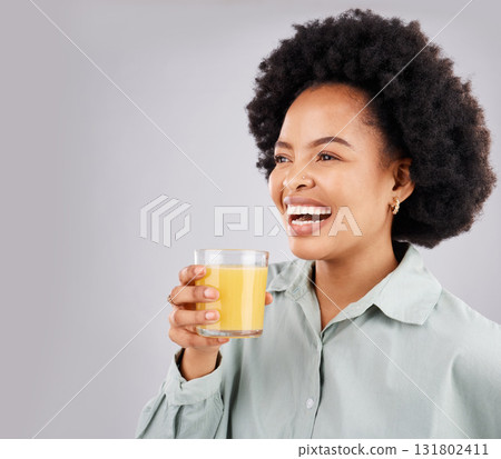 Thinking, mockup and orange juice with a laughing woman in studio on a gray background for health or vitamin c. Idea, drink and glass with a happy young female drinking a fresh beverage for nutrition 131802411