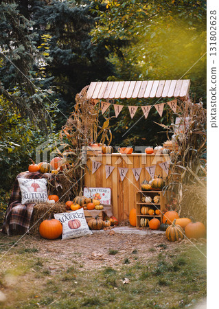 Rustic Fall Farm Market Display with Pumpkins, Corn Stalks and Seasonal Decor 131802628