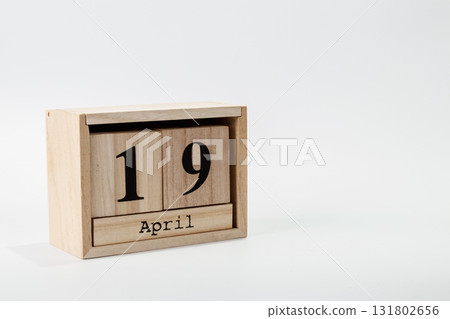 Wooden calendar April 19 on a white background Wooden calendar April 19 on a white background 131802656