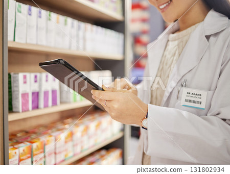 Hands, tablet and stock in a pharmacy with a woman drugstore at work, checking shelves for a product. Healthcare, medicine and trust with a female pharmacist working in a store for the sale of drugs 131802934