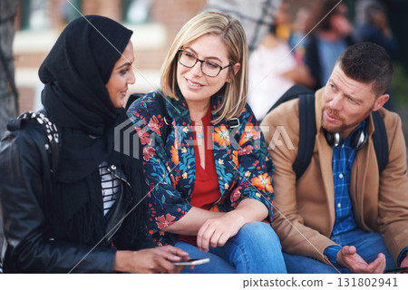 Friends, diversity and happy people with communication and connection outdoor on stairs. Hijab, muslim and talking women and adult learning and international student community on college steps 131802941