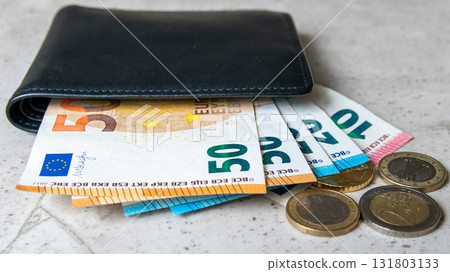 Black partmone with euro money. Coins and bills in leather wallet for commerce concept. Space for text. Black partmone with euro money. Coins and bills in leather wallet for commerce concept. Space for text. 131803133