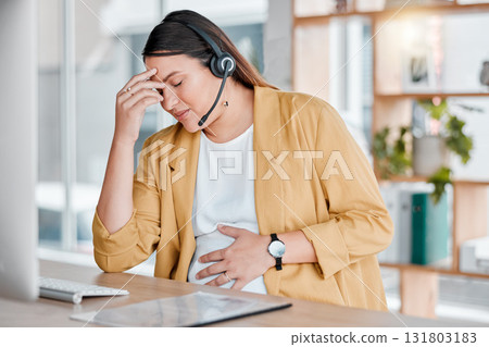 Call center, headache and pregnancy, woman at desk with hand on stomach, exhausted in office with headset. Burnout, pain and pregnant telemarketing consultant with anxiety from deadline time stress. Call center, headache and pregnancy, woman at desk with hand on stomach, exhausted in office with headset. Burnout, pain and pregnant telemarketing consultant with anxiety from deadline time stress. 131803183