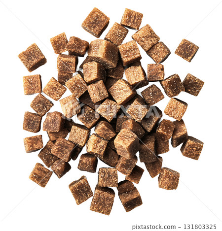A pile of brown sugar cubes is scattered on transparent background 131803325