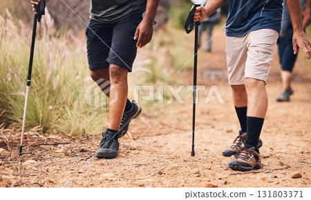 Hiking, fitness and feet of people walking on mountain for adventure, freedom and journey in nature. Travel, retirement and shoes of hikers with walk cane for exercise wellness, trekking and workout Hiking, fitness and feet of people walking on mountain for adventure, freedom and journey in nature. Travel, retirement and shoes of hikers with walk cane for exercise wellness, trekking and workout 131803371