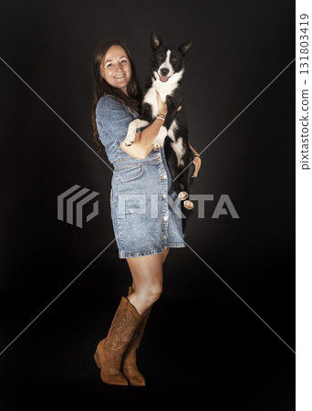 puppy border collie and woman 131803419