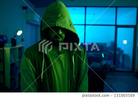 Man, hacking or dark hoodie in neon living room with cybersecurity, software programming or phishing mystery. Hacker, hood or night clothes with secret virus ideas of fraud scam, crime or theft 131803589