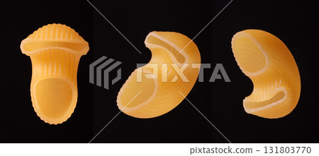 Close-up of unusually shaped pasta on a black background. Close-up of unusually shaped pasta on a black background. 131803770