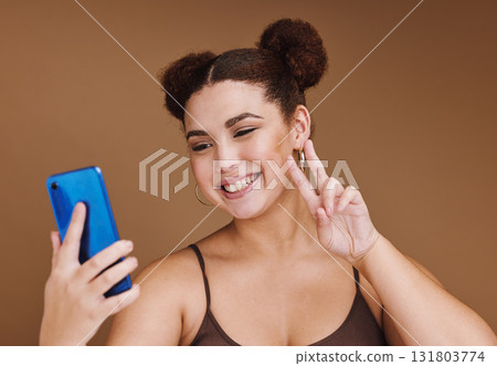Selfie, peace sign and black woman with phone feeling excited, happy and beauty for profile picture. Social media, isolated and studio background with mockup of gen z, young and face of a model Selfie, peace sign and black woman with phone feeling excited, happy and beauty for profile picture. Social media, isolated and studio background with mockup of gen z, young and face of a model 131803774