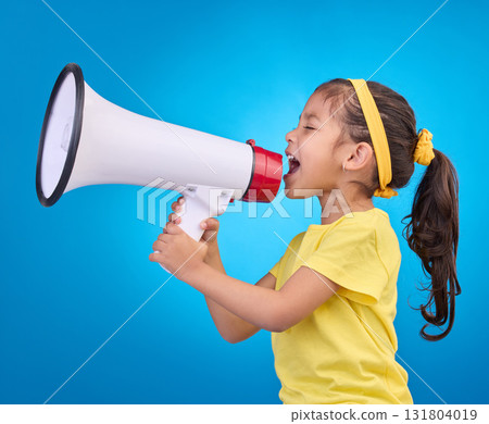 Communication, shout and child with megaphone for news, opinion and announcement on blue background. Talking, speaking mockup and young girl with loudspeaker for voice, scream and attention in studio 131804019