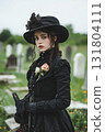 Woman in mourning attire visits military cemetery to honor fallen soldiers and memories 131804111