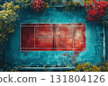 Aerial view of a vibrant outdoor tennis court surrounded by trees in different autumn colors 131804126