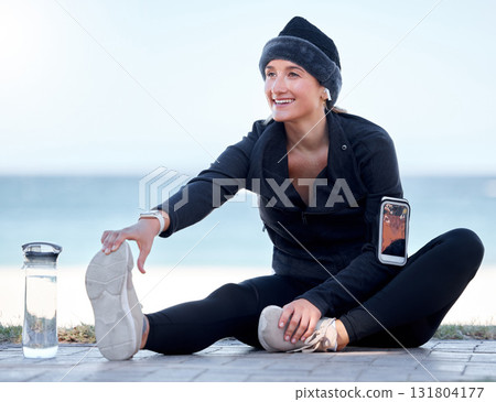 Fitness, woman and stretching legs by beach in preparation for exercise, cardio workout or training. Happy sporty female in warm up leg stretch getting ready for fun exercising by the ocean on mockup 131804177