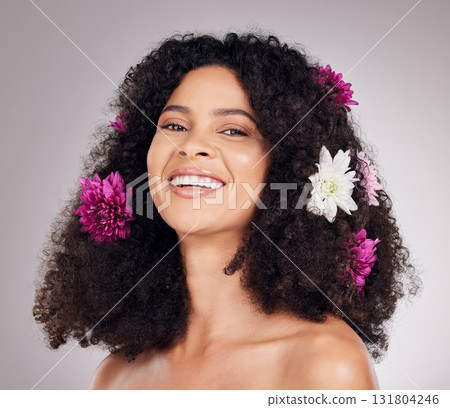 Portrait, smile or face of black woman with flowers in hair in studio background for spring, sustainable or self care. Natural, beauty facial or girl model with plant for skincare, cosmetic or makeup Portrait, smile or face of black woman with flowers in hair in studio background for spring, sustainable or self care. Natural, beauty facial or girl model with plant for skincare, cosmetic or makeup 131804246