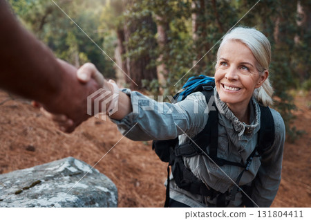 Hiking, helping hand and people in nature for climbing adventure, senior wellness and support for health. Happy woman or couple of friends hands reaching for teamwork on mountains or forest trekking Hiking, helping hand and people in nature for climbing adventure, senior wellness and support for health. Happy woman or couple of friends hands reaching for teamwork on mountains or forest trekking 131804411