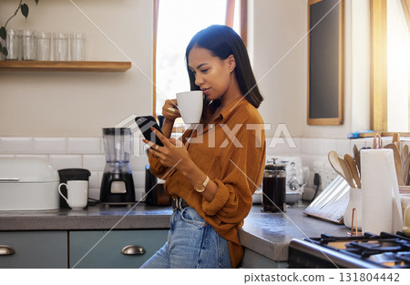 Relax, kitchen and woman with phone, coffee and browsing internet, checking social media or reading email. Chat, connect and work from home lifestyle, latino girl freelancer on tea break in apartment 131804442