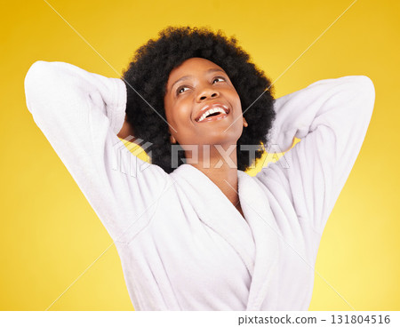 Black woman relax, bathrobe and happiness in a studio ready for luxury spa treatment for self care. Isolated, yellow background and happy young female with a smile from skincare and wellness 131804516