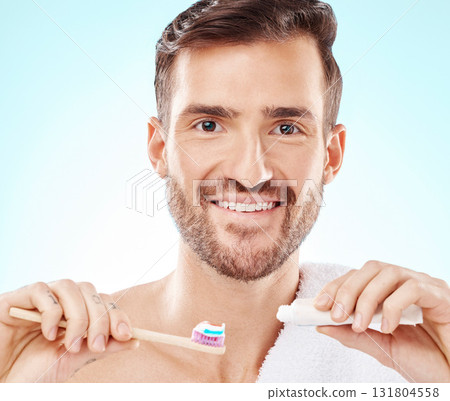 Smile, portrait or happy man brushing teeth with dental toothpaste for healthy oral hygiene grooming in studio. Eco friendly, smile or male model cleaning mouth with a natural bamboo wood toothbrush Smile, portrait or happy man brushing teeth with dental toothpaste for healthy oral hygiene grooming in studio. Eco friendly, smile or male model cleaning mouth with a natural bamboo wood toothbrush 131804558