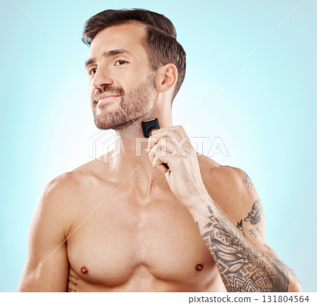 Beard portrait, man and shaving with trimmer in studio isolated on a blue background for hair removal. Haircare, grooming and male model with electric shaver to shave for hygiene, health and wellness Beard portrait, man and shaving with trimmer in studio isolated on a blue background for hair removal. Haircare, grooming and male model with electric shaver to shave for hygiene, health and wellness 131804564