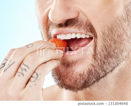Health, eating and strawberry with mouth of man for diet, detox and nutrition product. Wellness, smile and teeth with model and biting fruit closeup for vitamin c, glow and fiber in blue background 131804648