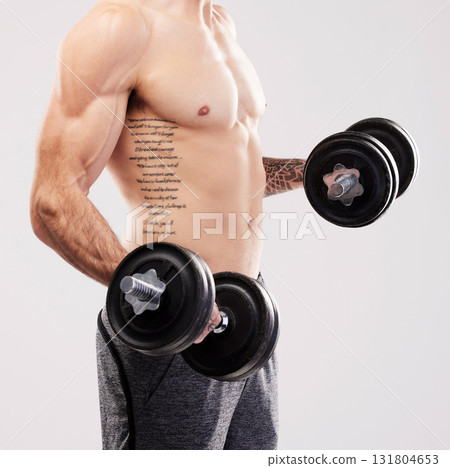 Arms muscle, dumbbells and bodybuilder man workout in studio for fitness and exercise with tattoo. Gray background, isolated and gym model weightlifting, bodybuilding or doing body wellness training Arms muscle, dumbbells and bodybuilder man workout in studio for fitness and exercise with tattoo. Gray background, isolated and gym model weightlifting, bodybuilding or doing body wellness training 131804653