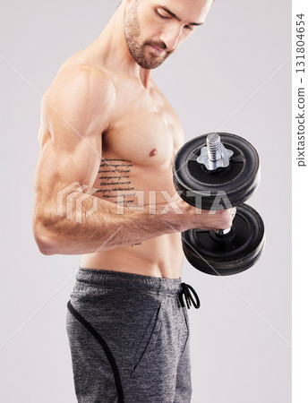Arm training, dumbbell and bodybuilder man workout in a studio for fitness, exercise and power. Gray background, isolated and gym model weightlifting, bodybuilding focus and doing body wellness Arm training, dumbbell and bodybuilder man workout in a studio for fitness, exercise and power. Gray background, isolated and gym model weightlifting, bodybuilding focus and doing body wellness 131804654