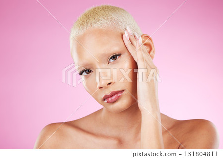 Portrait, beauty and makeup with a black woman in studio on a pink background for edgy cosmetics. Face, skincare or natural with a unique and attractve young female model indoor for cosmetic care Portrait, beauty and makeup with a black woman in studio on a pink background for edgy cosmetics. Face, skincare or natural with a unique and attractve young female model indoor for cosmetic care 131804811