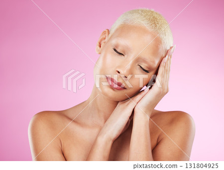 Woman, beauty and skincare cosmetics in makeup or facial treatment against a pink studio background. Female face and hands touching soft, smooth or gentle skin in satisfaction for self love or care 131804925