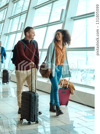 Travel, love and smile with interracial couple in airport for vacation, tourism and departure. International trip, luggage and holiday with man and black woman walking for flight, journey or airline 131805099