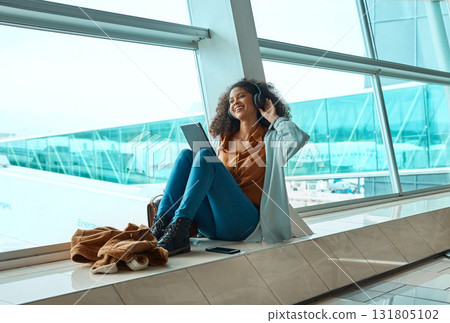 Black woman, headphones and travel with tablet, airport and listening to music with business trip or holiday. Happy, flight and vacation with traveling, conference or convention with technology Black woman, headphones and travel with tablet, airport and listening to music with business trip or holiday. Happy, flight and vacation with traveling, conference or convention with technology 131805102