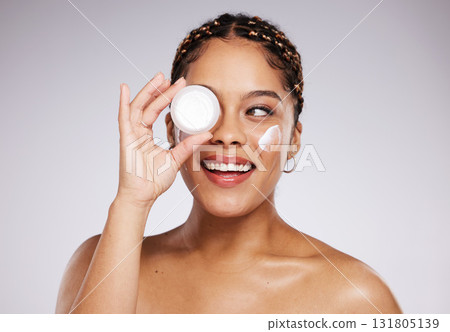 Skincare, health and woman with face cream in a studio for a beauty, natural and face routine. Cosmetic, wellness and female model with facial creme, spf or moisturizer treatment by a gray background Skincare, health and woman with face cream in a studio for a beauty, natural and face routine. Cosmetic, wellness and female model with facial creme, spf or moisturizer treatment by a gray background 131805139